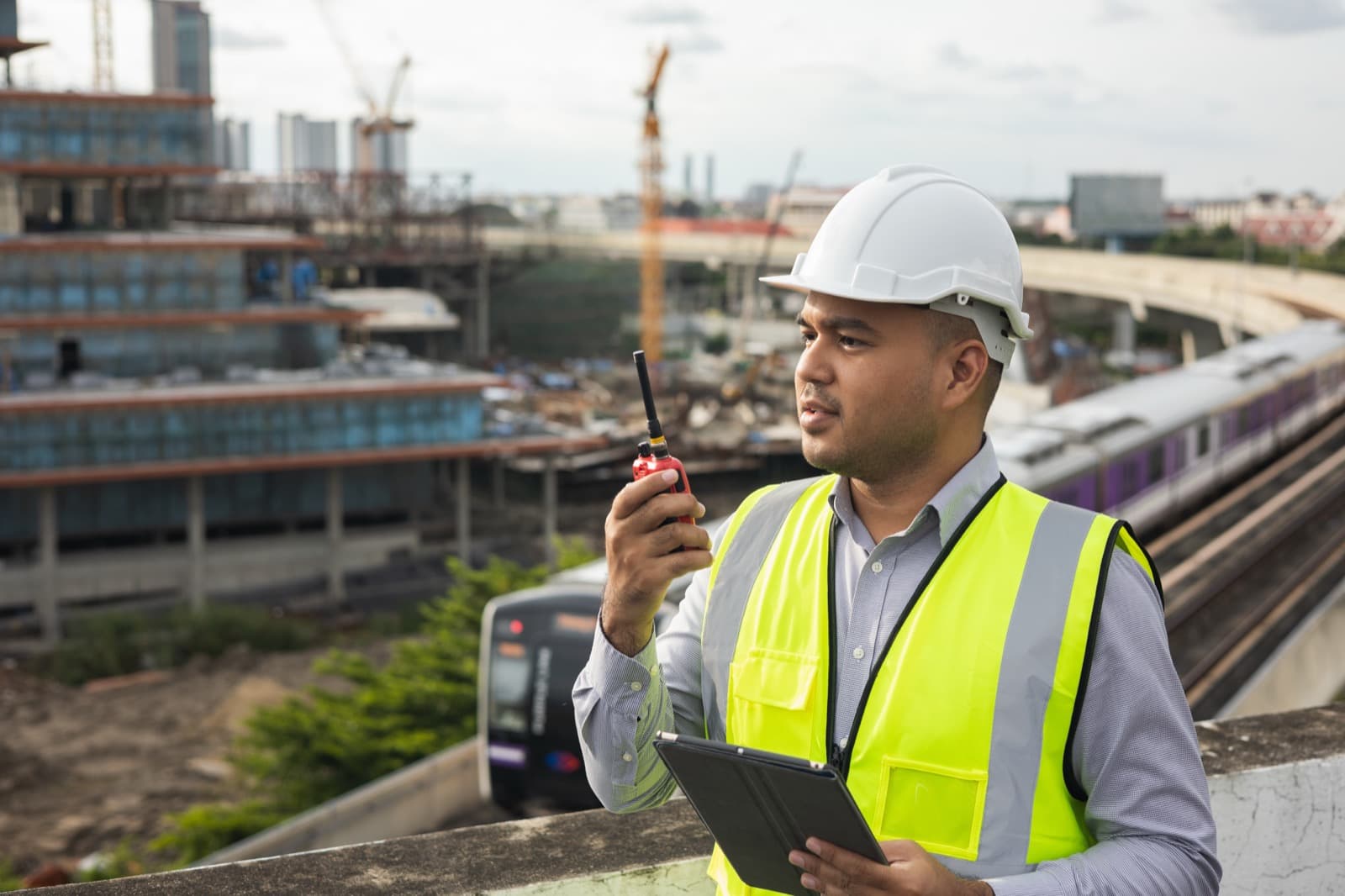 Rail worker using a radio in a transit environment